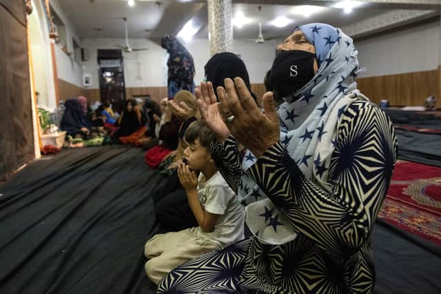 It is ordinary Afghan people, like these refugees from Kunduz praying at a mosque in Kabul, who are suffering most (Picture: Paula Bronstein /Getty Images)