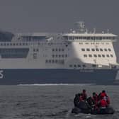 An inflatable craft carrying migrants crosses the shipping lane in the English Channel.