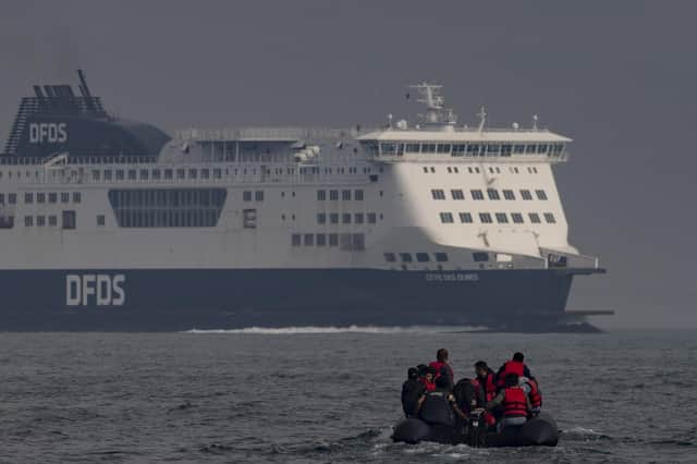 An inflatable craft carrying migrants crosses the shipping lane in the English Channel.