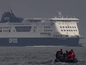 An inflatable craft carrying migrants crosses the shipping lane in the English Channel.