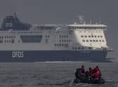 An inflatable craft carrying migrants crosses the shipping lane in the English Channel.