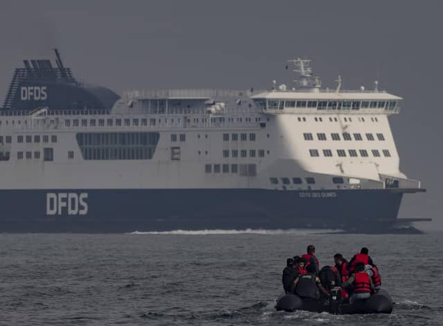An inflatable craft carrying migrants crosses the shipping lane in the English Channel.