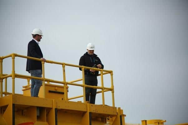 Mocean’s Cameron McNatt and Wave Energy Scotland’s Tim Hurst christen the device with a bottle of Highland Park whisky