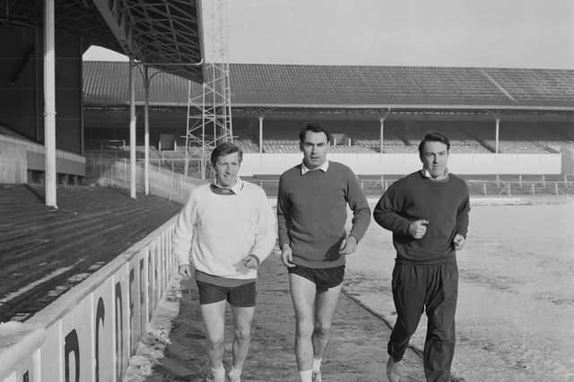 (Left to right) Cliff Jones, Alan Gilzean and Jimmy Greaves doing laps of White Hart Lane in January 1965. (Photo by J. R. Watkins/Daily Express/Hulton Archive/Getty Images)
