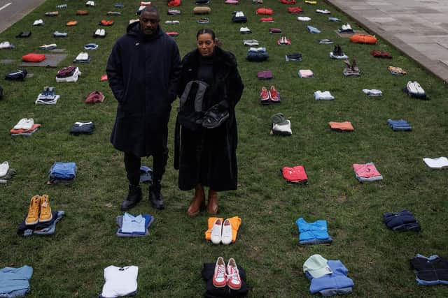 Actor Idris Elba poses with Yemi Hughes, the mother of Andre Aderemi, 19, who was chased and killed with a sword in Croydon, in front of an installation of over 200 bundles of clothing, representing lives lost to knife crime (Picture: Dan Kitwood/Getty Images)
