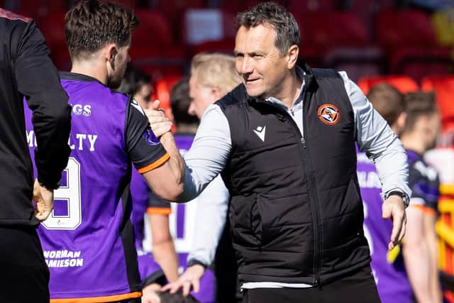 United manager Micky Mellon congratulates McNulty on his two goals.