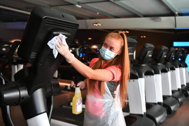 Gillian Davidson (21) health and fitness coach, helps prepare David Lloyd Glasgow Rouken Glen for opening on Monday.