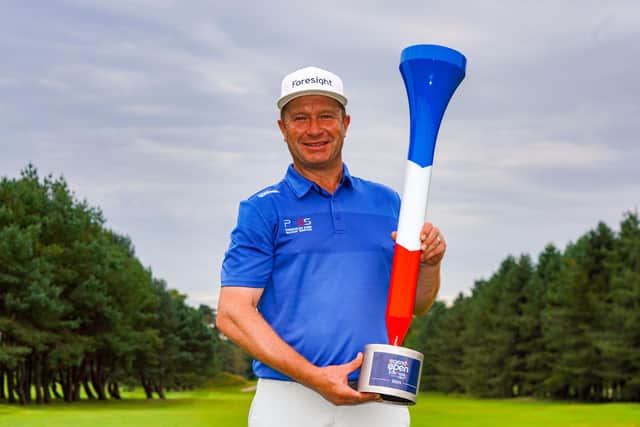 Greig Hutcheon shows off the trophy after landing his maiden win on the European Legends Tour. Picture: Getty Images