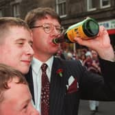 Eric Milligan enjoys a wee sip of Buckfast wine with Hearts fans after their team beat Rangers 2-1 to win the Scottish Cup 1998  Pic Adam Elder