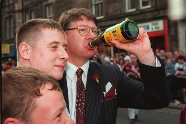Eric Milligan enjoys a wee sip of Buckfast wine with Hearts fans after their team beat Rangers 2-1 to win the Scottish Cup 1998 Pic Adam Elder