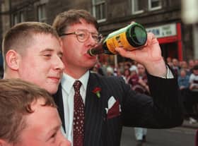 Eric Milligan enjoys a wee sip of Buckfast wine with Hearts fans after their team beat Rangers 2-1 to win the Scottish Cup 1998  Pic Adam Elder