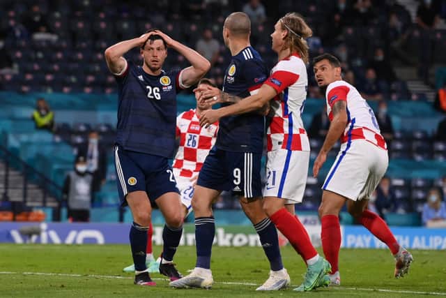 Scott McKenna (left) shows his frustration after missing a chance against Croatia at Hampden during the Euro 2020 finals in June. (Photo by STU FORSTER/POOL/AFP via Getty Images)