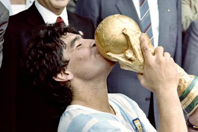 Maradona gets his hands on the World Cup.