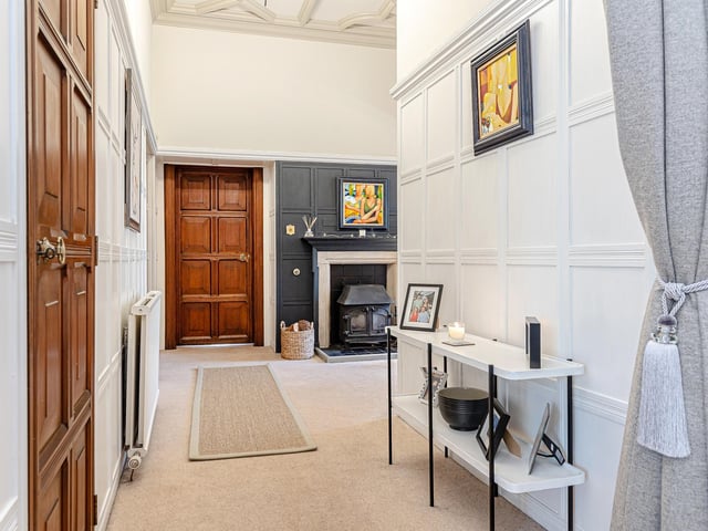 The ground-floor porch opens to a bright ground-floor hallway leading to a bay-windowed lounge, spacious drawing room with a feature fireplace, and the rear family hub, off which are a conservatory and roof cupola-lit staircase.