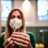 A medical staff member prepares a syringe with a dose of the Pfizer-BioNTech Covid-19 vaccine at a temporary vaccination centre in Paris. France made Covid-19 booster shots available to all adults on November 25. (Photo by STEPHANE DE SAKUTIN / AFP) (Photo by STEPHANE DE SAKUTIN/AFP via Getty Images)