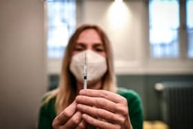 A medical staff member prepares a syringe with a dose of the Pfizer-BioNTech Covid-19 vaccine at a temporary vaccination centre in Paris. France made Covid-19 booster shots available to all adults on November 25. (Photo by STEPHANE DE SAKUTIN / AFP) (Photo by STEPHANE DE SAKUTIN/AFP via Getty Images)