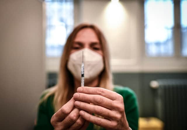 A medical staff member prepares a syringe with a dose of the Pfizer-BioNTech Covid-19 vaccine at a temporary vaccination centre in Paris. France made Covid-19 booster shots available to all adults on November 25. (Photo by STEPHANE DE SAKUTIN / AFP) (Photo by STEPHANE DE SAKUTIN/AFP via Getty Images)