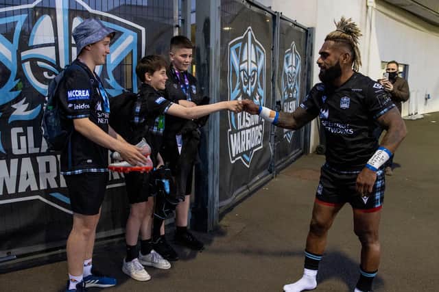 Niko Matawalu gives his boots to young Glasgow Warriors fans after his final match for the club, against Leinster. Picture: Alan Harvey/SNS