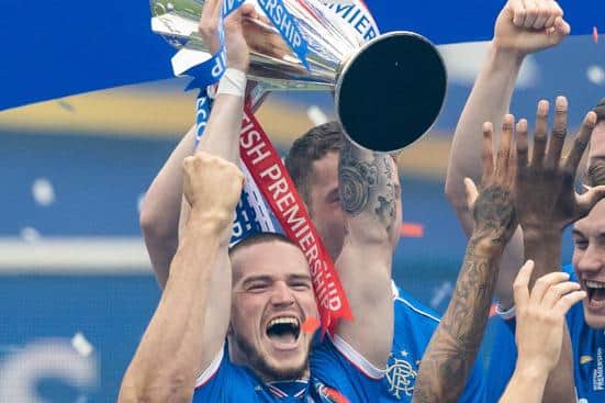 Ryan Kent lifts the Premiership trophy at Ibrox in May. (Photo by Craig Williamson / SNS Group)