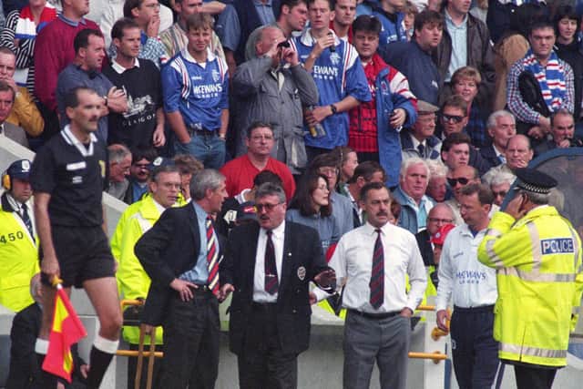 Hearts chief executive Chris Robinson (3rd right) chats with Rangers manager Walter Smith on the touchline at Ibrox after the visitors were reduced to seven players after four red cards.