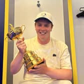 A smiling Bob MacIntyre enjoys having his hands on the Ryder Cup in the European team locker-room in Rome. Picture: Bob MacIntyre