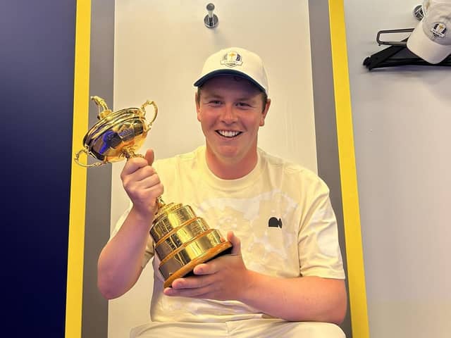 A smiling Bob MacIntyre enjoys having his hands on the Ryder Cup in the European team locker-room in Rome. Picture: Bob MacIntyre