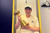 A smiling Bob MacIntyre enjoys having his hands on the Ryder Cup in the European team locker-room in Rome. Picture: Bob MacIntyre
