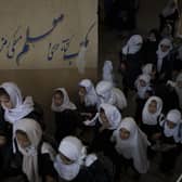 Girls walk upstairs as they enter a school before class in Kabul (AP Photo/Felipe Dana)