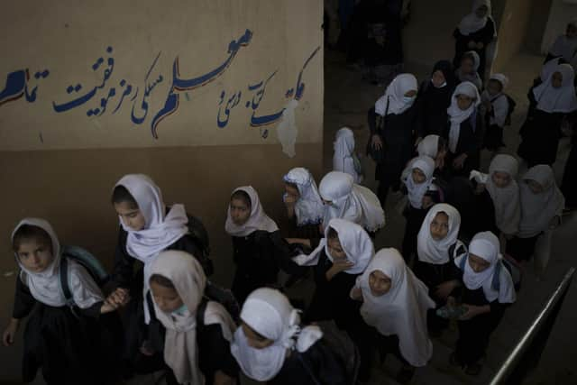 Girls walk upstairs as they enter a school before class in Kabul (AP Photo/Felipe Dana)