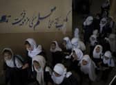Girls walk upstairs as they enter a school before class in Kabul (AP Photo/Felipe Dana)