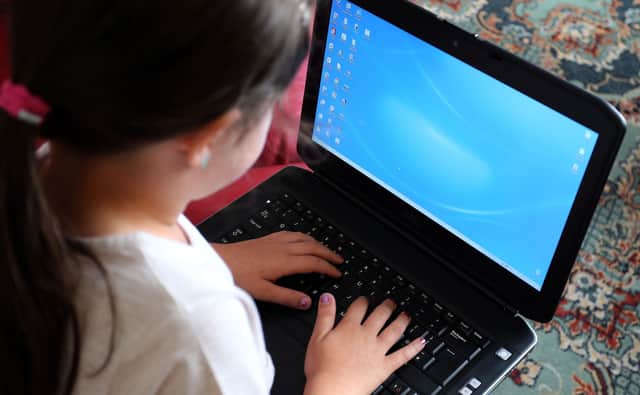 A child using a laptop computer, as a "tsunami" of online child abuse is taking place in the UK, the NSPCC has said. Picture: Peter Byrne/PA Wire