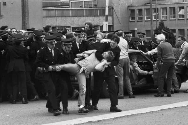 Members of the NUM miners' union picket line clash with police outside Bilston Glen colliery during the miners strike in June 1984.