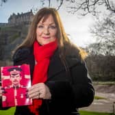 Theresa Davidson with a picture of her late husband Lance Sergeant Clark Mitchell in front of Edinburgh Castle.