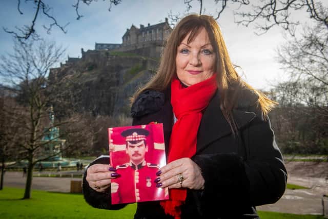 Theresa Davidson with a picture of her late husband Lance Sergeant Clark Mitchell in front of Edinburgh Castle.