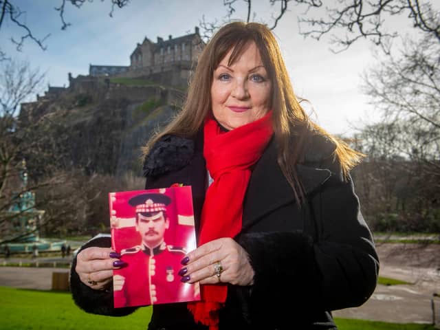 Theresa Davidson with a picture of her late husband Lance Sergeant Clark Mitchell in front of Edinburgh Castle.