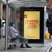 People wait at a bus stop in Glasgow. Picture: Andrew Milligan/PA Wire