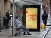 People wait at a bus stop in Glasgow. Picture: Andrew Milligan/PA Wire