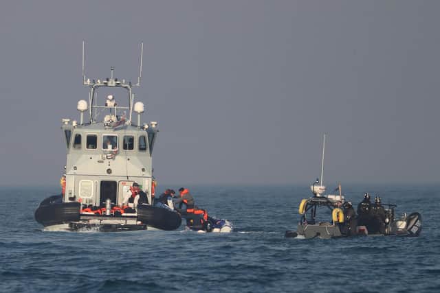 Border Force officers assist 20 Syrian migrants aboard HMC Hunter after they were stopped as they crossed The Channel in an inflatable dinghy headed in the direction of England.