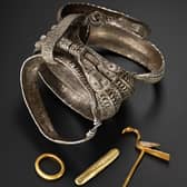 The silver bracelets and gold bird pin found among the collection that was buried in Galloway. PIC: NMS.