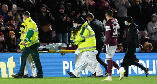 Hearts' Beni Baningime leaves the filed on a stretcher.