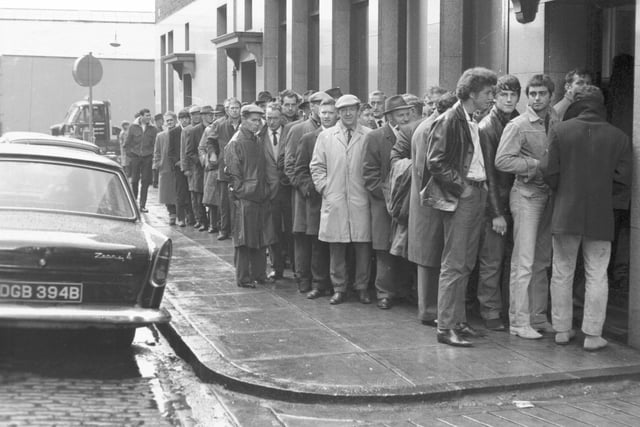 Members of the National Union of Seamen queue up to collect their first strike pay from Watt Street, Glasgow, in May 1966.