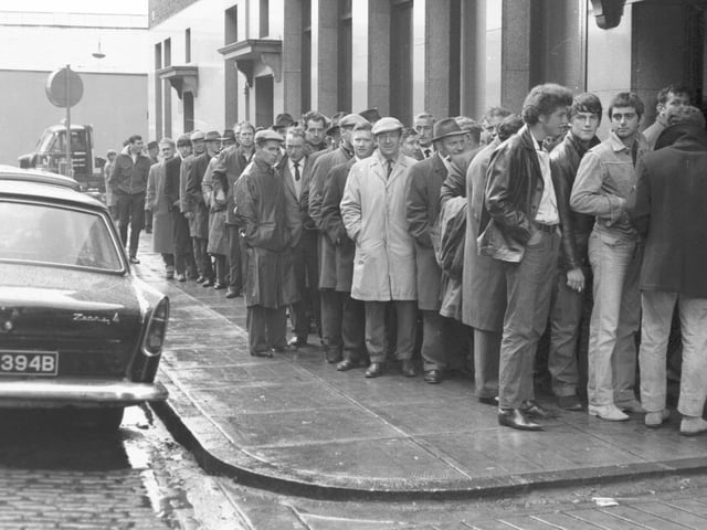 Members of the National Union of Seamen queue up to collect their first strike pay from Watt Street, Glasgow, in May 1966.