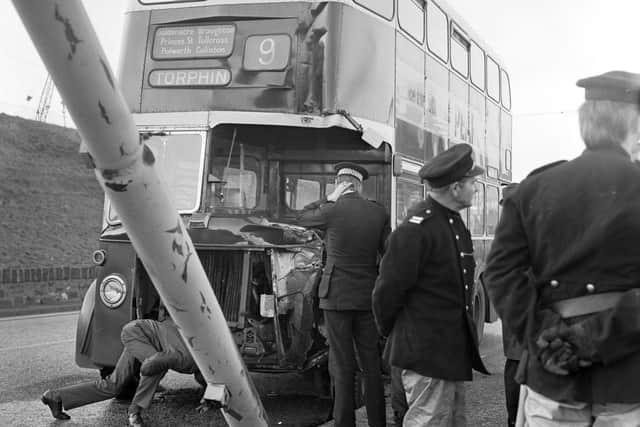 Police and an Edinburgh Corporation employee look at the damage after a No 9 bus crashed into a lampost in Granton in November 1974   Pic Bill Stout
