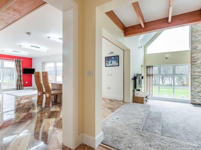 Hall access to kitchen on left and sitting room on right.