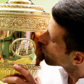Novak Djokovic of Serbia kisses the trophy after defeating Matteo Berrettini to win Wimbledon last year.