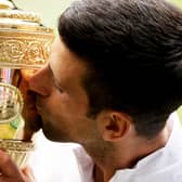 Novak Djokovic of Serbia kisses the trophy after defeating Matteo Berrettini to win Wimbledon last year.