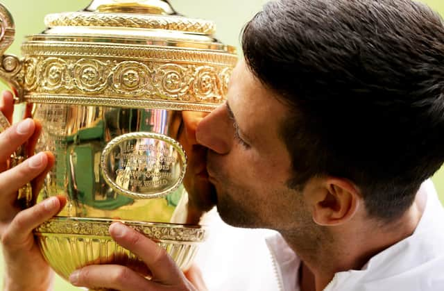 Novak Djokovic of Serbia kisses the trophy after defeating Matteo Berrettini to win Wimbledon last year.