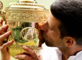 Novak Djokovic of Serbia kisses the trophy after defeating Matteo Berrettini to win Wimbledon last year.