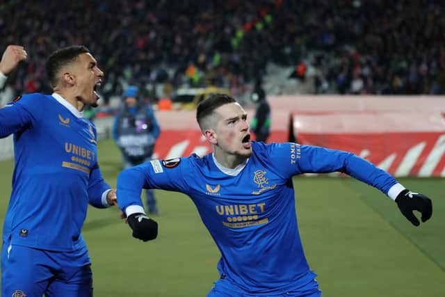BELGRADE, SERBIA - MARCH 17: Ryan Kent of Rangers celebrates with team mate James Tavernier after scoring their sides first goal during the UEFA Europa League Round of 16 Leg Two match between Crvena Zvezda and Rangers FC at Rajko Mitic Stadium on March 17, 2022 in Belgrade, Serbia. (Photo by Srdjan Stevanovic/Getty Images)