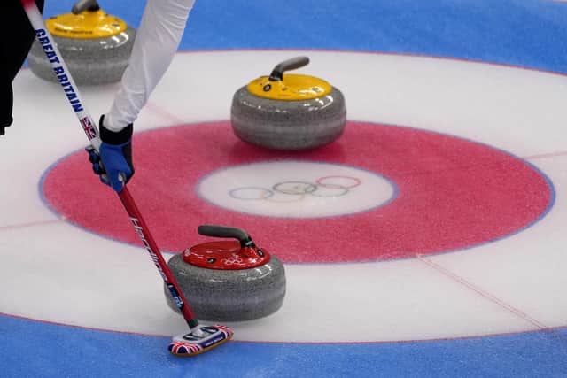 The Ailsa Craig stones on show as Great Britain's Bruce Mouat, of Stirling, sweeps the ice during the semifinal match with the United States with Thursday's match earning GB a place in the final. (AP Photo/Nariman El-Mofty)